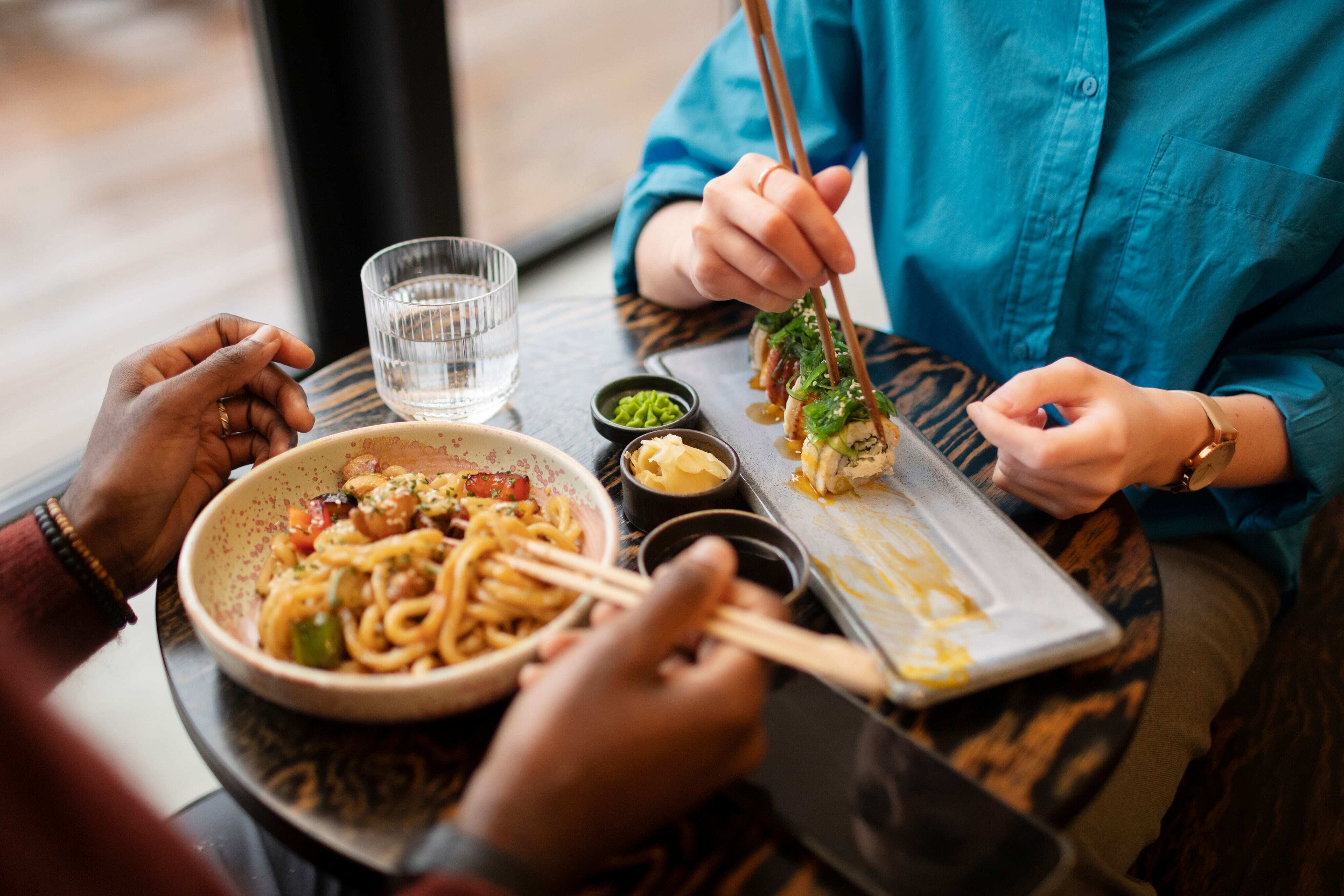 couple-enjoying-food-restaurant-min