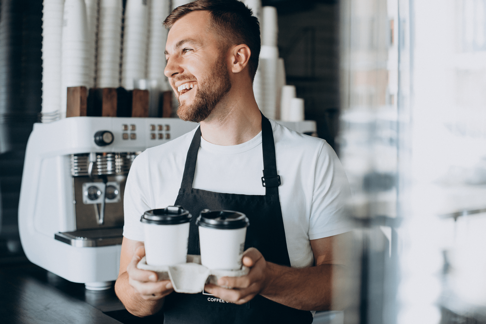 male-barista-with-take-away-coffee-min